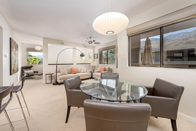 carpeted dining space featuring a wealth of natural light and ceiling fan