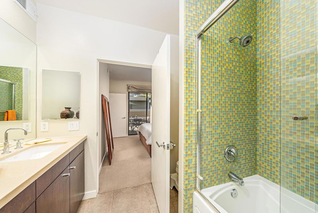 full bathroom featuring tile patterned floors, vanity, toilet, and shower / bath combination with glass door