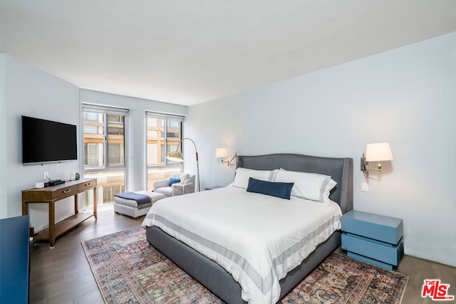 bedroom with dark hardwood / wood-style flooring