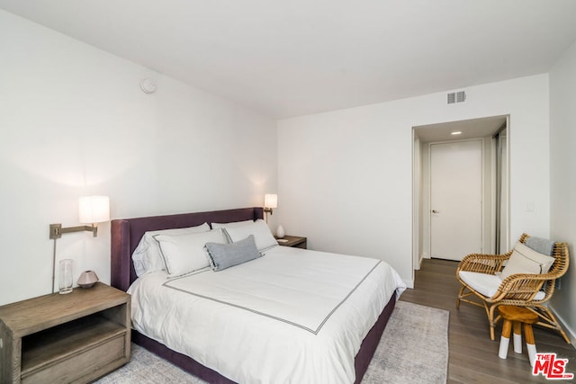 bedroom with hardwood / wood-style floors