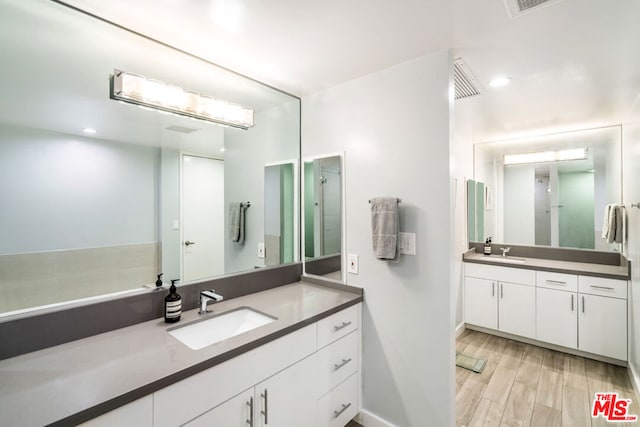 bathroom with vanity and wood-type flooring