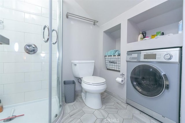 bathroom featuring washer / clothes dryer, a shower with door, and toilet