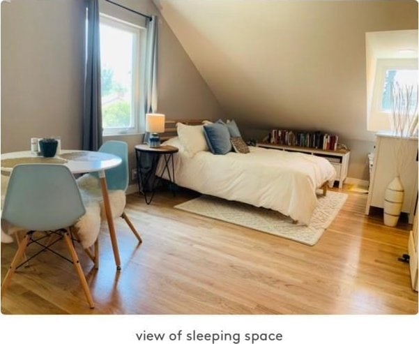 bedroom featuring lofted ceiling and wood-type flooring