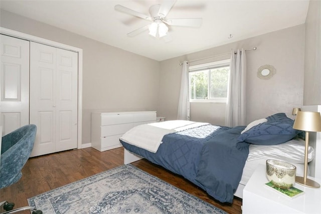 bedroom featuring ceiling fan, a closet, and dark wood-type flooring