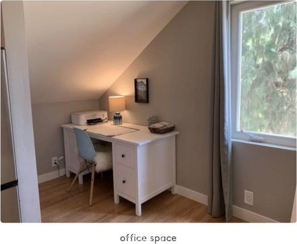 office area featuring light hardwood / wood-style floors and vaulted ceiling