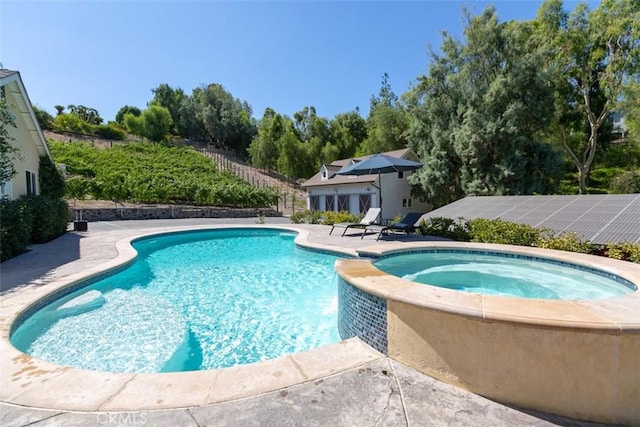 view of pool with a patio area and an in ground hot tub