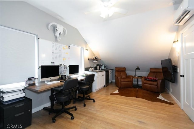 office featuring vaulted ceiling, light hardwood / wood-style floors, an AC wall unit, and ceiling fan