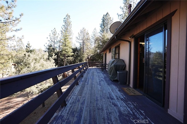 wooden terrace with a grill