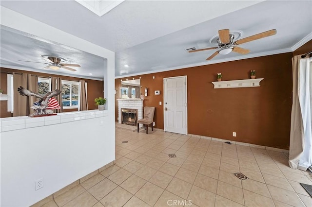 interior space with crown molding, light tile patterned floors, and a brick fireplace