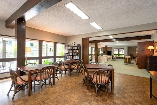 dining area featuring a textured ceiling and parquet flooring