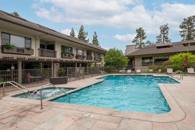 view of pool featuring a patio area and a jacuzzi