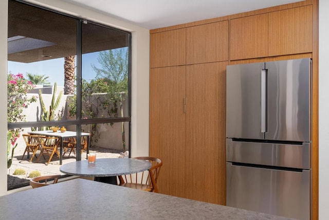 kitchen with stainless steel fridge and plenty of natural light