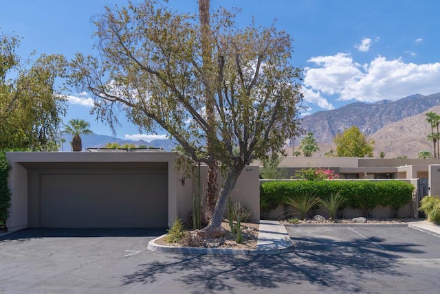 view of front facade featuring a mountain view and a garage