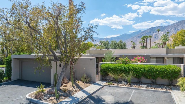 view of front of property with a mountain view and a garage