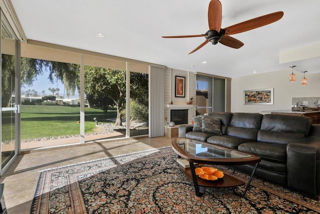 living room featuring expansive windows and a brick fireplace