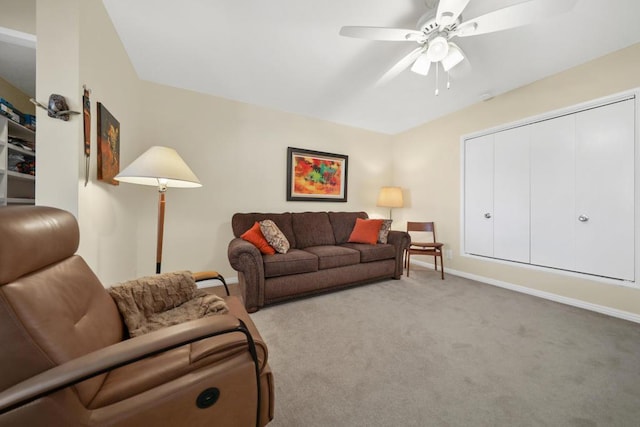 carpeted living room with ceiling fan