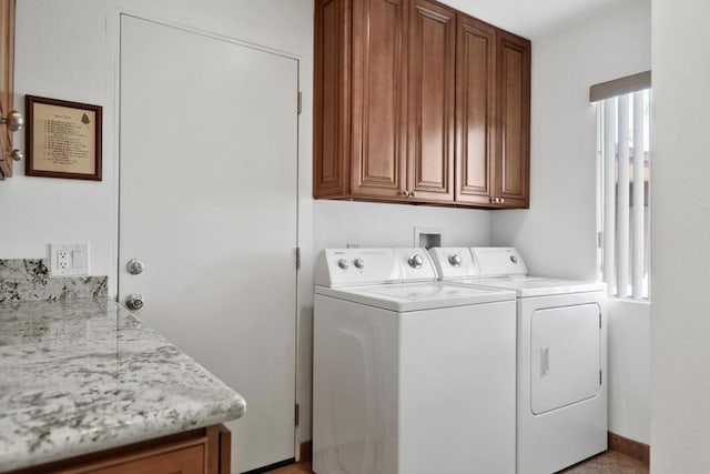 laundry room with cabinets and washing machine and clothes dryer