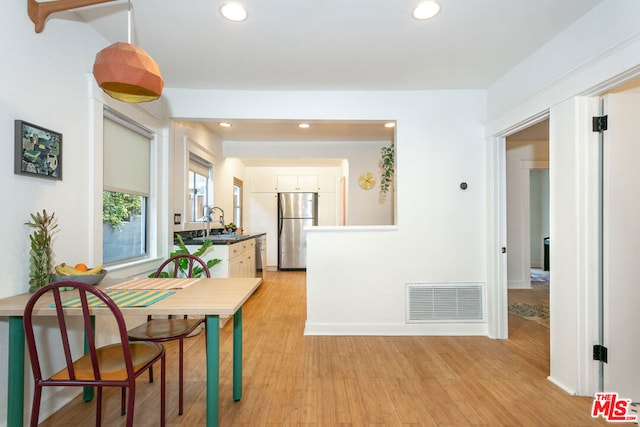 hall featuring light hardwood / wood-style floors and sink