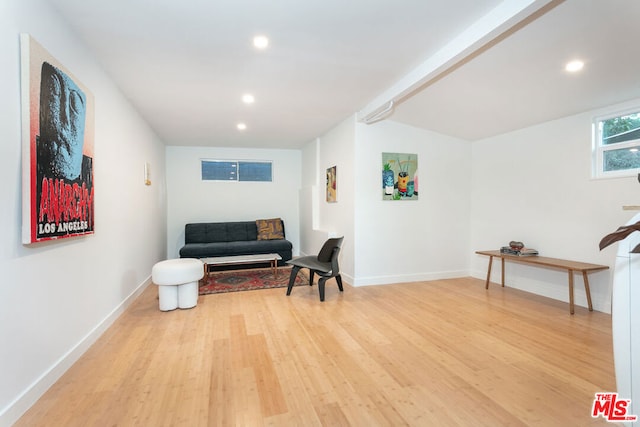 sitting room featuring hardwood / wood-style flooring and lofted ceiling with beams