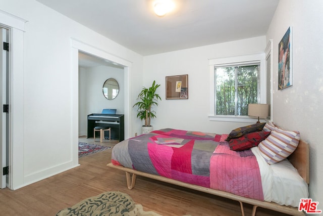 bedroom with wood-type flooring