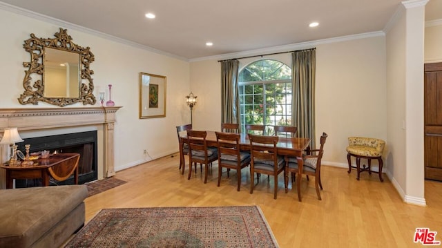 dining space with light wood-type flooring and crown molding