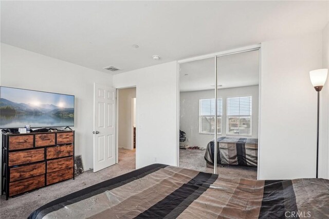 bedroom featuring carpet, a closet, and visible vents