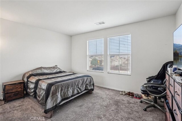 carpeted bedroom featuring baseboards and visible vents