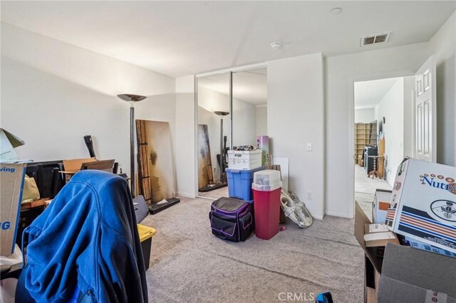 interior space with carpet and visible vents