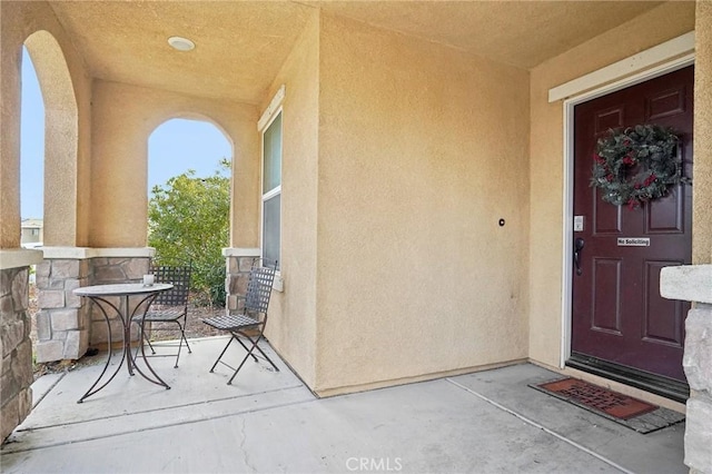 doorway to property featuring stucco siding