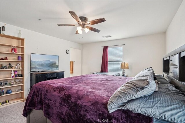 carpeted bedroom featuring ceiling fan and visible vents