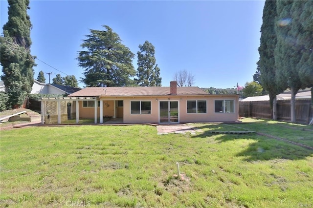 rear view of property with a patio area and a lawn