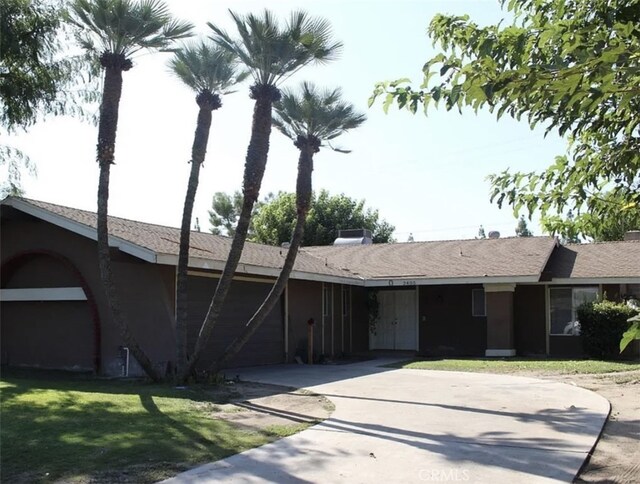 view of front of home with a garage and a front lawn