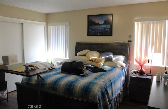 bedroom featuring a closet and dark wood finished floors