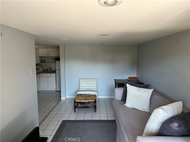 unfurnished living room with sink and light tile patterned flooring