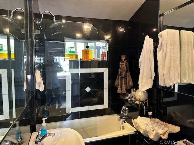 bathroom featuring tiled tub and sink