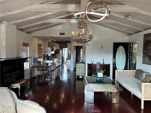 living room with vaulted ceiling with beams, wooden ceiling, dark wood-type flooring, and an inviting chandelier