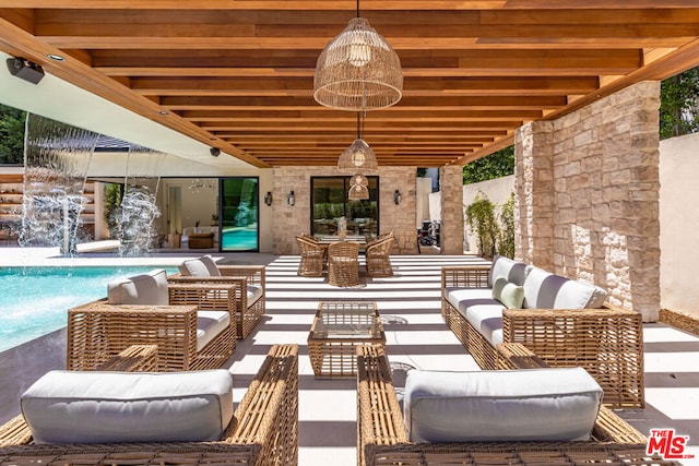 view of patio featuring pool water feature and outdoor lounge area