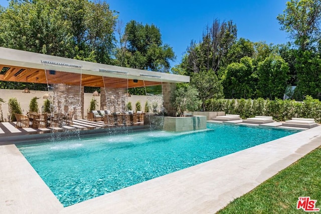 view of pool featuring pool water feature and a patio