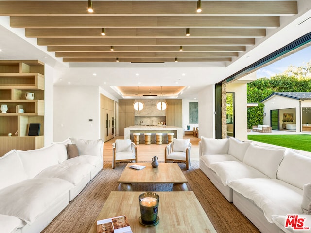 living room featuring beam ceiling and wood-type flooring