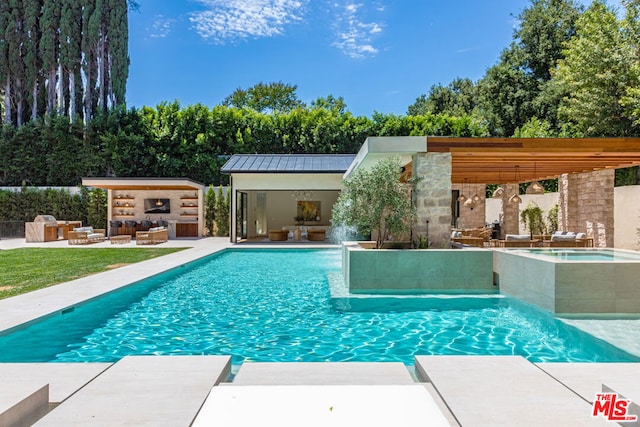 view of pool with a patio area, an outdoor living space, and an outbuilding