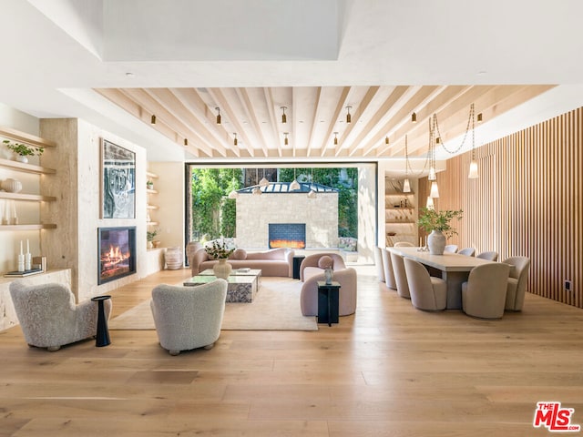 living room featuring light wood-type flooring and floor to ceiling windows