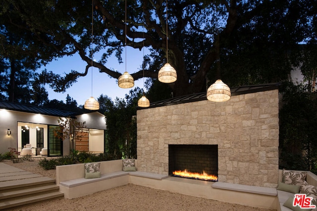 view of patio / terrace featuring an outdoor stone fireplace