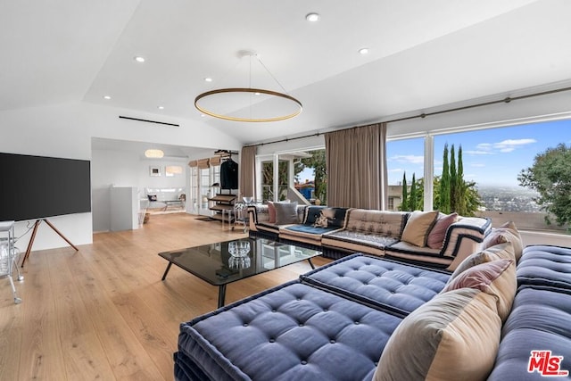 living room with light hardwood / wood-style floors and lofted ceiling