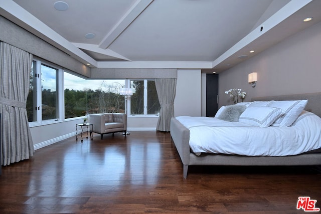 bedroom with lofted ceiling with beams and dark hardwood / wood-style flooring