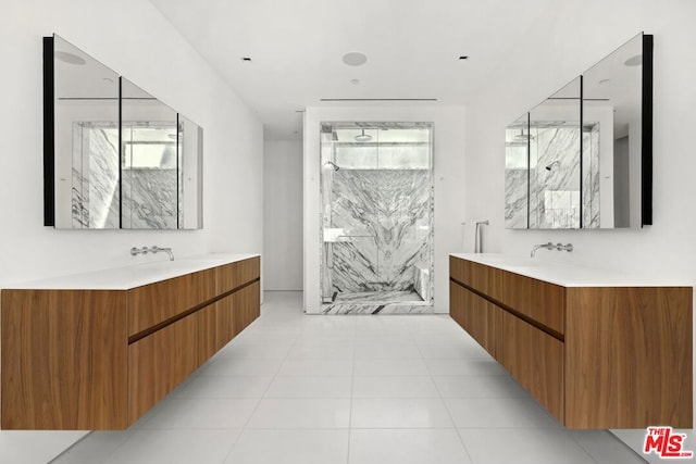 bathroom with tile patterned flooring, vanity, and an enclosed shower