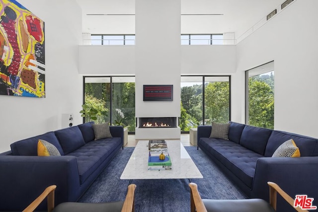 living room featuring a towering ceiling