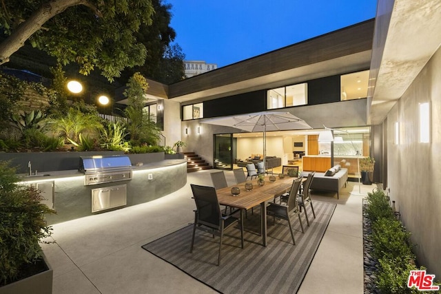 view of patio featuring an outdoor living space, an outdoor kitchen, and area for grilling