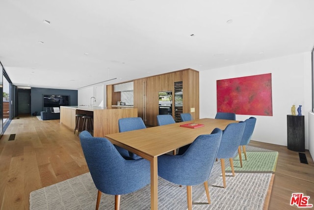 dining area featuring light hardwood / wood-style floors and sink