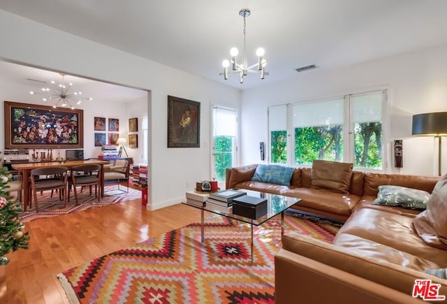 living room featuring hardwood / wood-style floors and an inviting chandelier