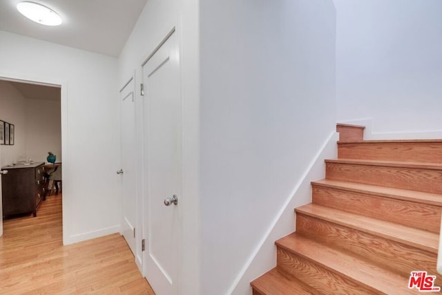 stairs with hardwood / wood-style flooring